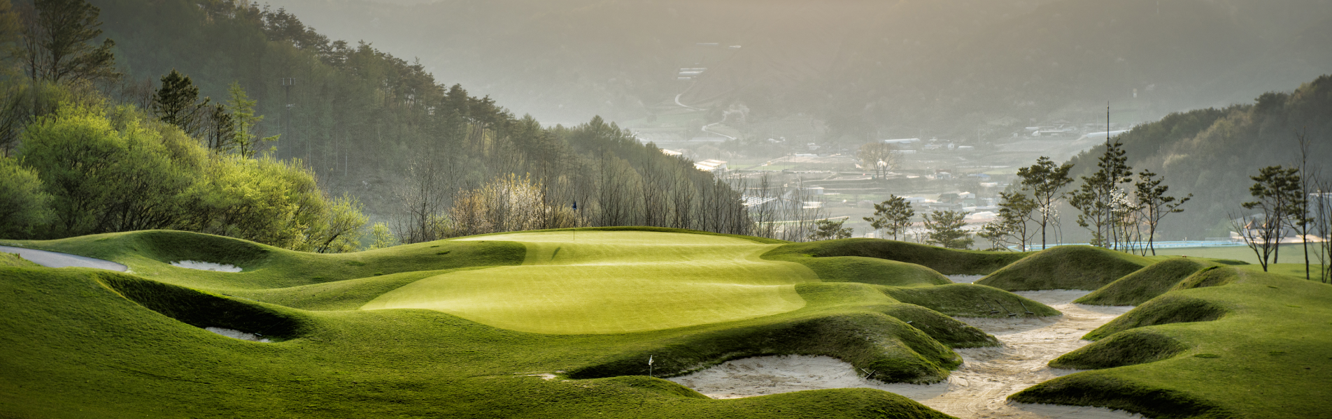 A beautiful resort building next to a golf course.